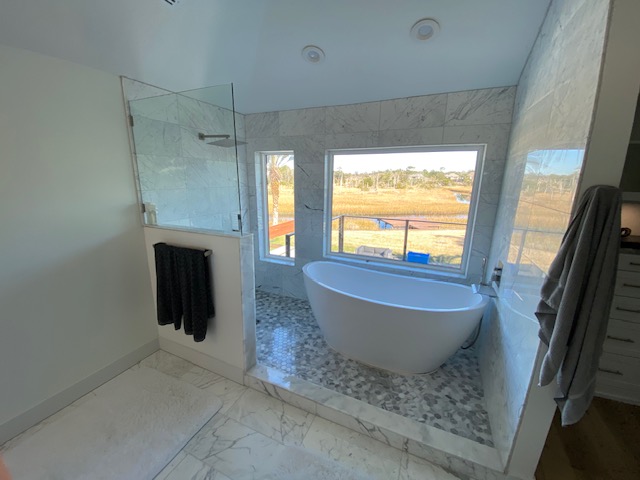 Marble bath with freestanding tub and glass shower