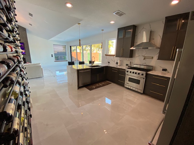 Finished kitchen with quartz island and dark cabinetry